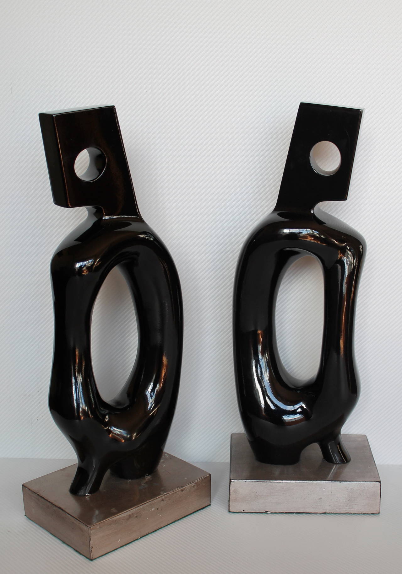 Set of two biomorphic organic carved lacquered wood sculptures.
Wood bases covered in metal leaf, 
Mexico, circa 1960s. Unsigned (unknown artist.)