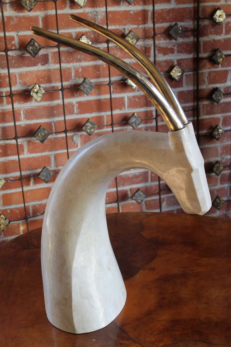 A beautiful 1970s tessellated stone gazelle sculpture with long brass antlers.