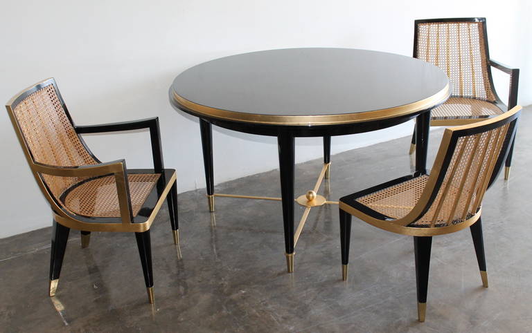Exceptional and Rare, high quality Dining Set by Arturo Pani.
In the style of Jean Royére.
Mexico City, circa 1950.
Dining Table with Two Caned Armchairs and Two Cane side Chairs, made of black lacquered mahogany and gold leaf.
original high