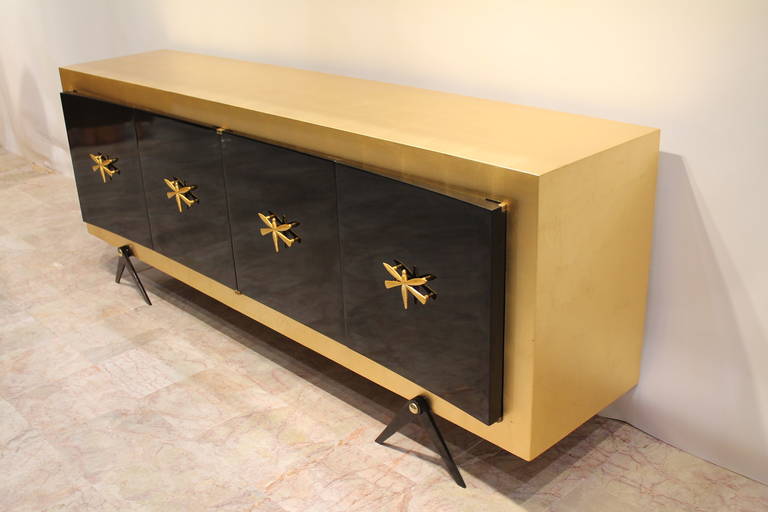 Exquisite custom gold leaf and black lacquer credenza or buffet,
by Arturo Pani,
Mexico, 1950,
Very, very rare and hard to find!

Mahogany covered in gold leaf and black lacquer.
Beautiful whimsical dragonfly pulls covered in 22-karat genuine
