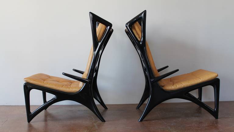 Beautiful 1950's Sculptural Italian Ebonized Wood and Leather Wing Lounge Chairs.

*another set of two lounge chairs and a matching love seat, also available.