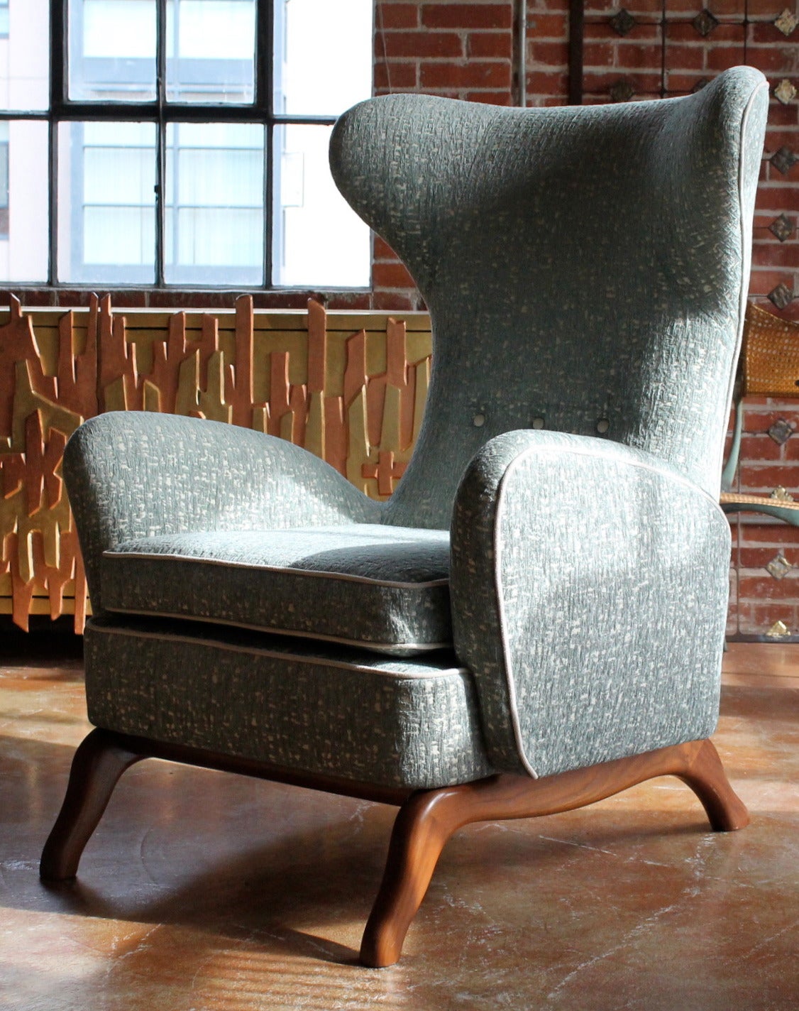 Stunning pair of highly stylized 1960s Italian sculptural wingback lounge chairs.
Beautiful lines and angles and large-scale.
Sculptural bases made of walnut.
Re-upholstered in high quality fabric.