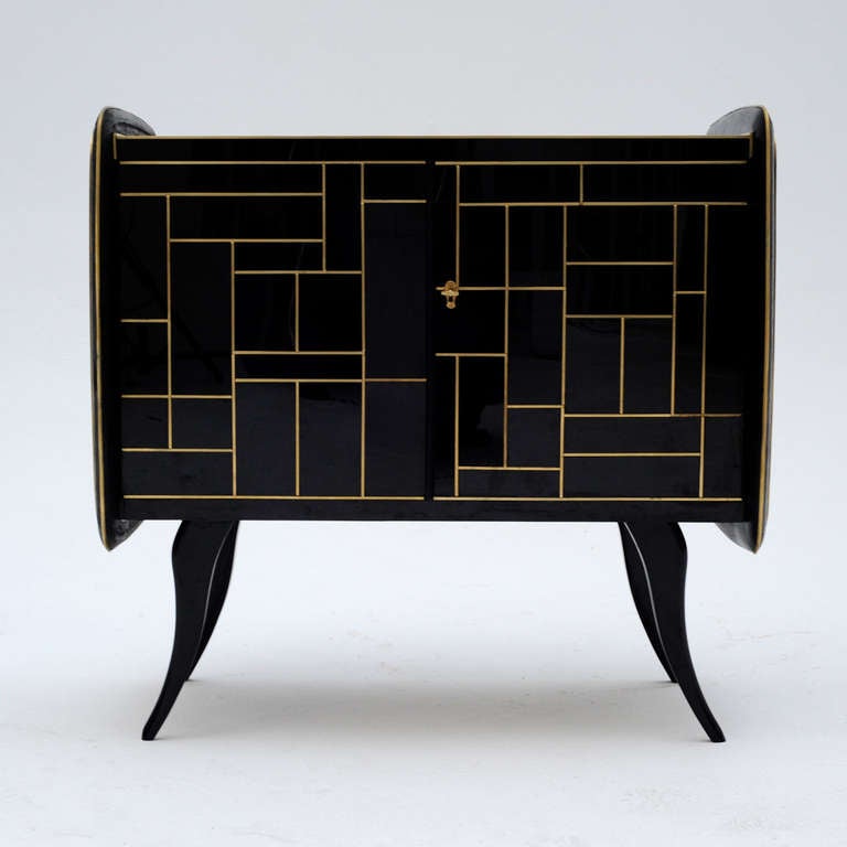 Pair of sideboards made in solid wood, covered by black Murano glass with handles and profiles in brass.  Italy 1950's.