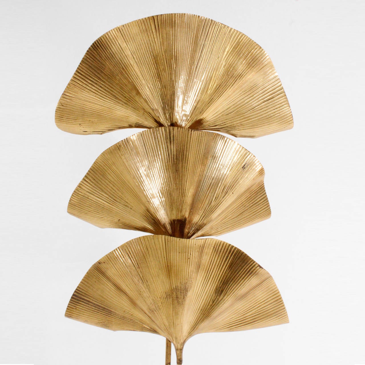 Sculptural floor lamp made in brass designed by Tommaso Barbi, composed by three leaf in ginko form.