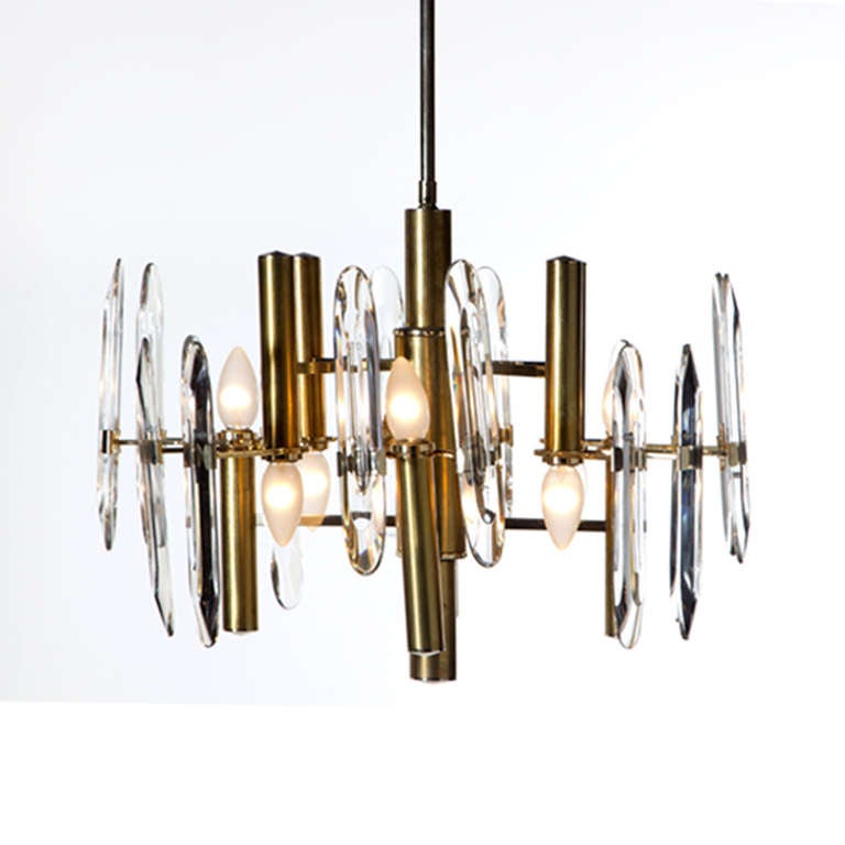 Pendant lamp of eight lights attributed to Gaetano Sciolari and edited by Circa. A structure made of brass with details made of bright brass and carved glass applications, Italy, 1970s. Measures: 50 x 100 cm.