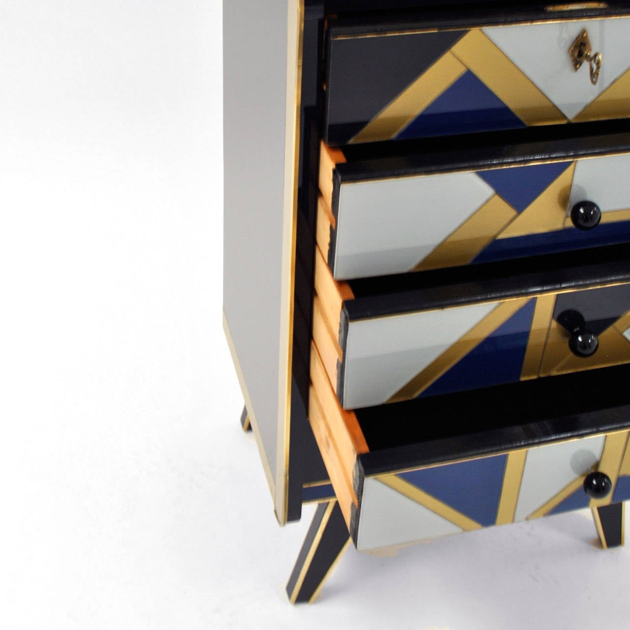 Commode composed of five drawers , made in solid wood coated Murano glass and brass details with geometric motifs. 
Italy 1950 .