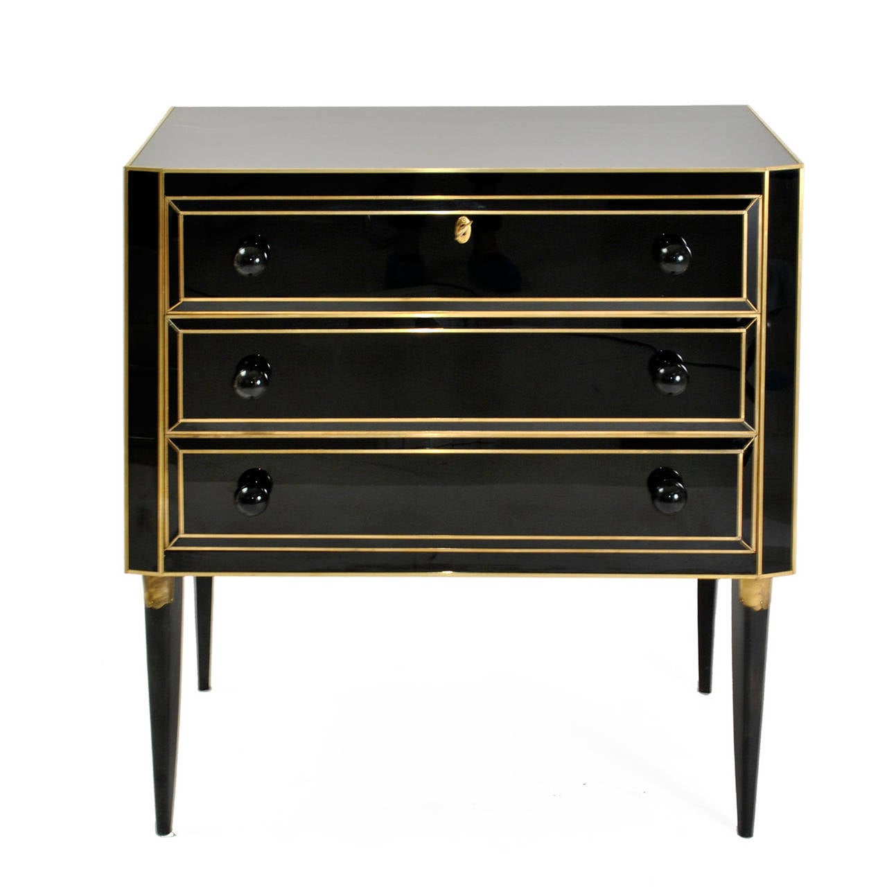 Pair of commodes composed by three drawers, made in solid wood covered in black Murano glass  with details in bronze and brass.