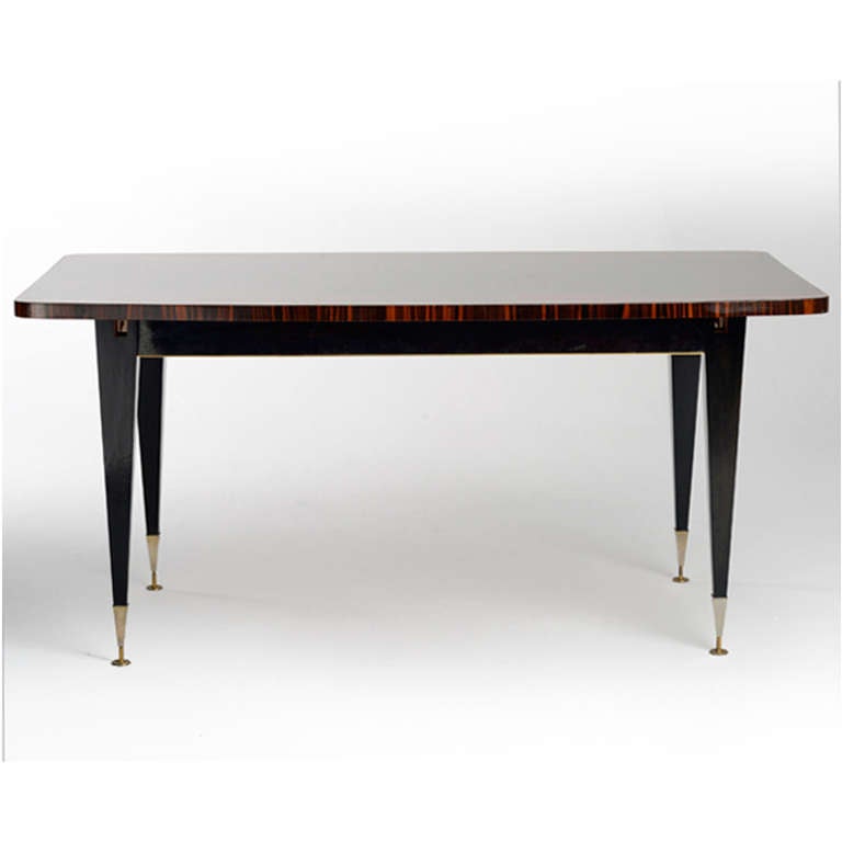 Dining table made in solid wood covered geometric marquetry in macassar ebony. Conical legs finished with brass. Italy 1940s.