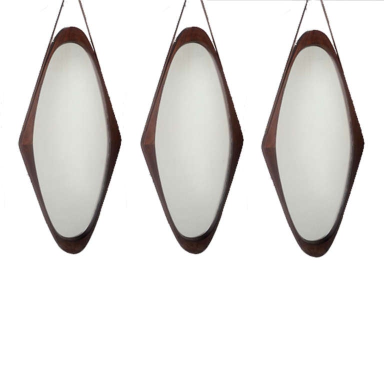 Set of three mirrors made in rosewood and leather strap. Italy 1950´s.