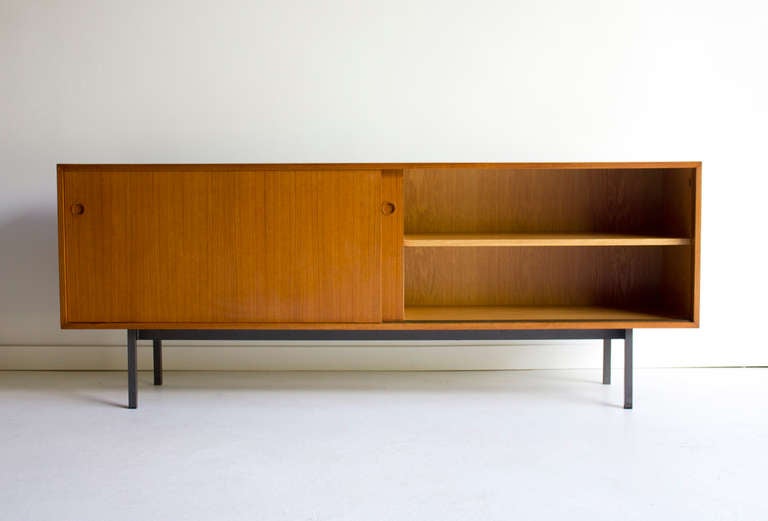 Walter Wirz teak credenza for Wilhelm Renz.

The credenza is in good vintage condition. The top does show signs of wear with scratching and imperfections due to use. One small spot on the top was previously restored however it is noticeable
