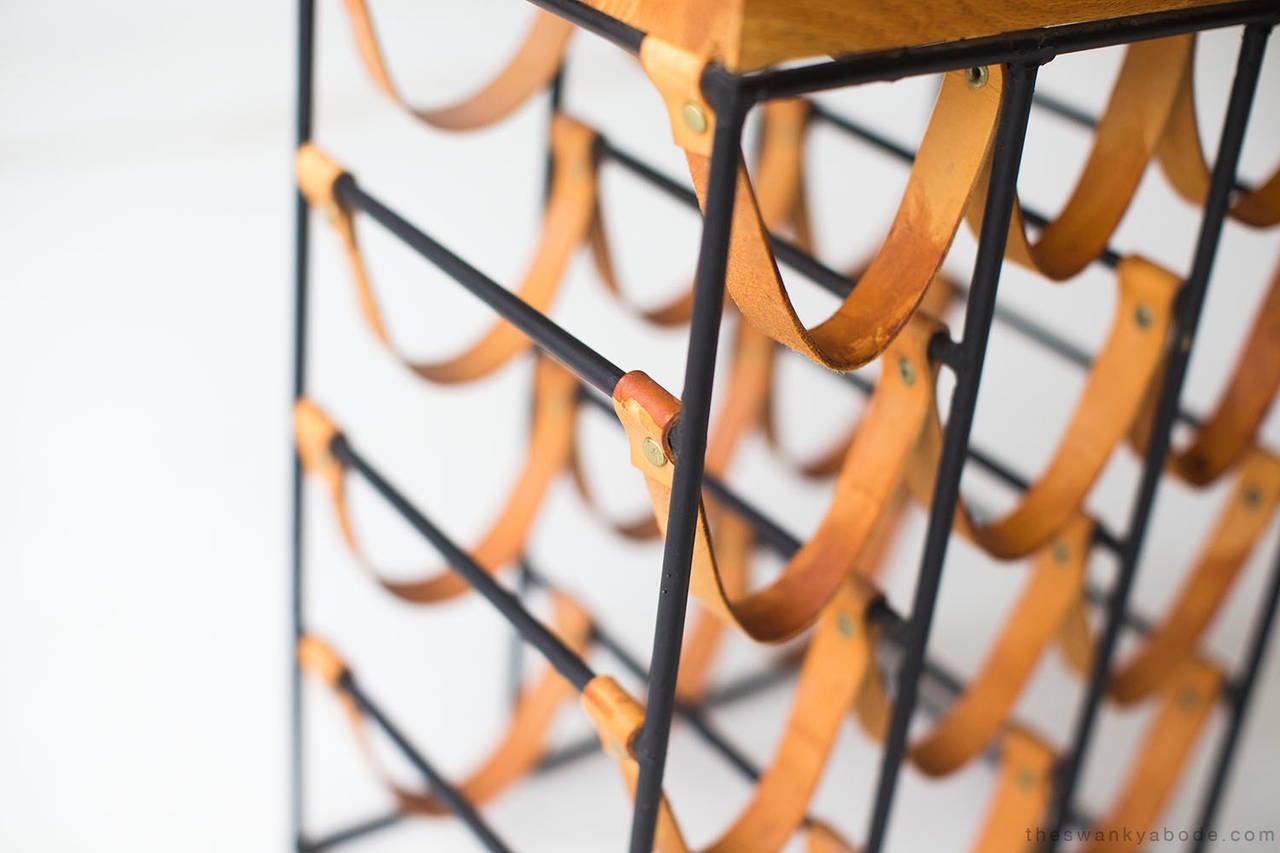 Designer: Arthur Umanoff.

Manufacturer: Unknown.
Period and model: Mid-Century Modern.
Specifications: Wrought iron.

Condition:

This Arthur Umanoff wrought iron and leather wine rack is in very good vintage condition with age appropriate