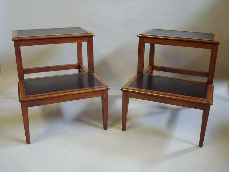 A rare pair of Regency mahogany library steps of elegant proportions; the two treads with a moulded edge and cross banded borders inset with black leather with tooled edges; raised on square tapering legs.