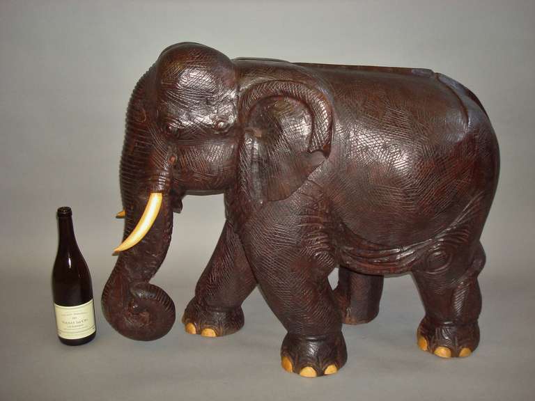 wooden elephant with ivory tusks