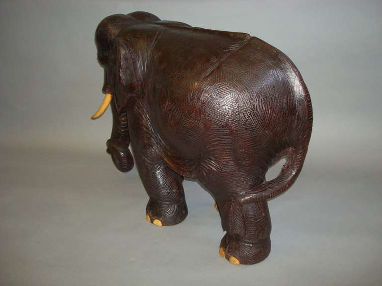 antique wooden elephants with ivory tusks