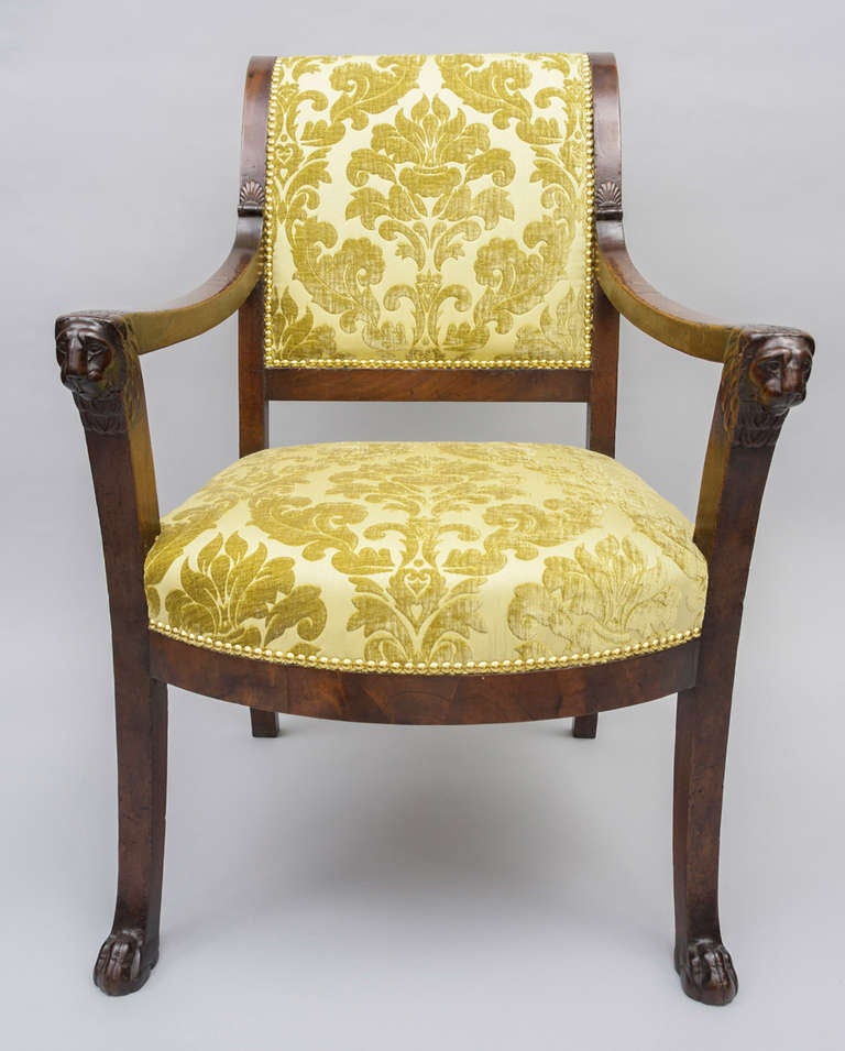 Early C19th near pair of mahogany Directoire fauteuils (open armchairs) in the manner of Jacob Freres.  The scroll back with mahogany top rail;  the uprights with carved shell motif and the arms terminating with well carved bold lions heads.  The