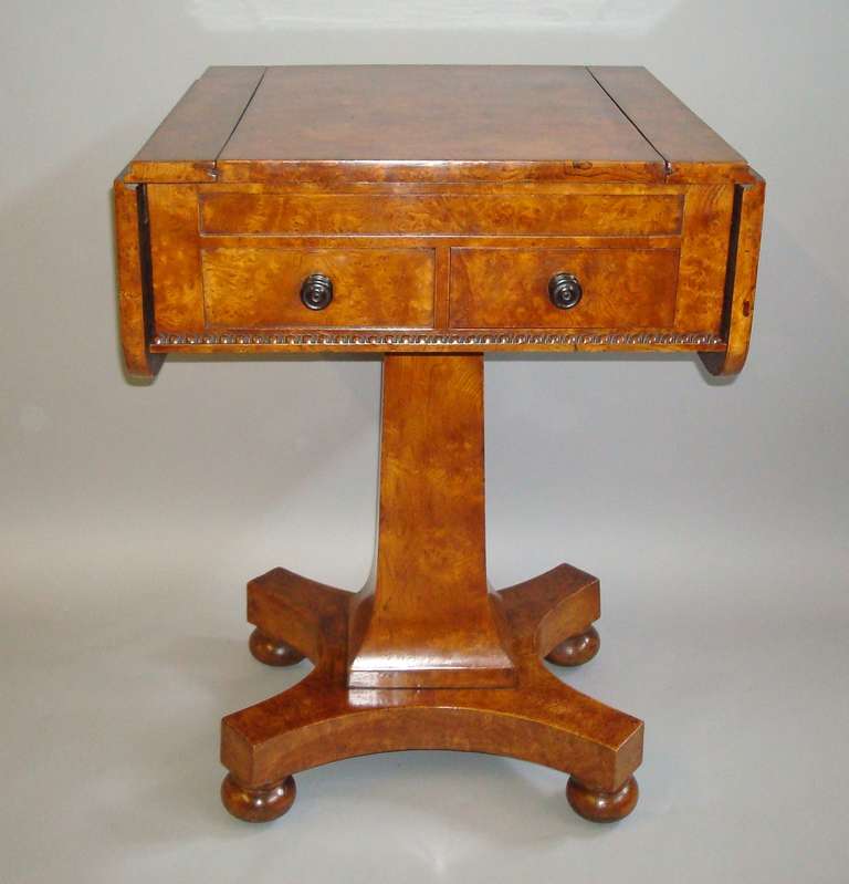 An excellent late Regency burr elm games table; the rectangular top with drop flaps to either side with rounded corners, the reversable burr elm central panel sliding out to display a maple and ebony chess board on the reverse; the sunken interior