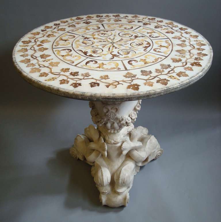 A very impressive mid C19th Italian marble centre table, the circular top profusely inlaid with brown alabaster and sienna marble incorporating a stylised foliate centre panel with a wide trailing grapevine border and a moulded edge, raised on a