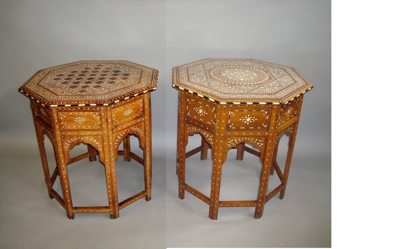 Late 19th Century matched pair of Hoshiarpur Indian occasional tables of large proportions; the octagonal teak tables with fine and elaborate bone inlay, one having a chess board centre with a profusely decorated border and ebony stringing;  the