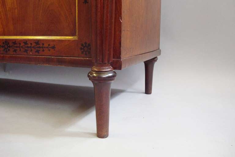Good Regency mahogany and ebony inlaid bookcase of small proportions.   The top section with a pair of glazed doors and gilt mouldings, the base with 2 cushion shaped drawers and a pair of very well figured panelled doors with gilt mouldings below;