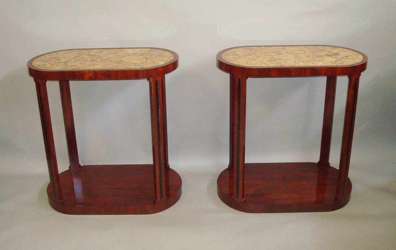 An exceptional 19th century pair of mahogany and marble end/centre tables; of unusual and stylish design, the shaped tops inset with 'Brèche d'Alep' marbles with narrow mahogany cross banding on a shallow frieze.  Raised on four pillasters with