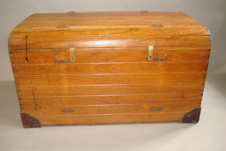 Rare Late C19th teak cabin travelling trunk of slatted construction.  The hinged lid with brass inlaid initials 