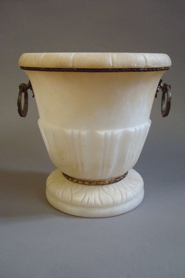 C19th alabaster and ormolu mounted wine cooler, of circular form with fluted decoration, ormolu beadings and side carrying handles.  (Large enough for a magnum of champagne as in image 6)