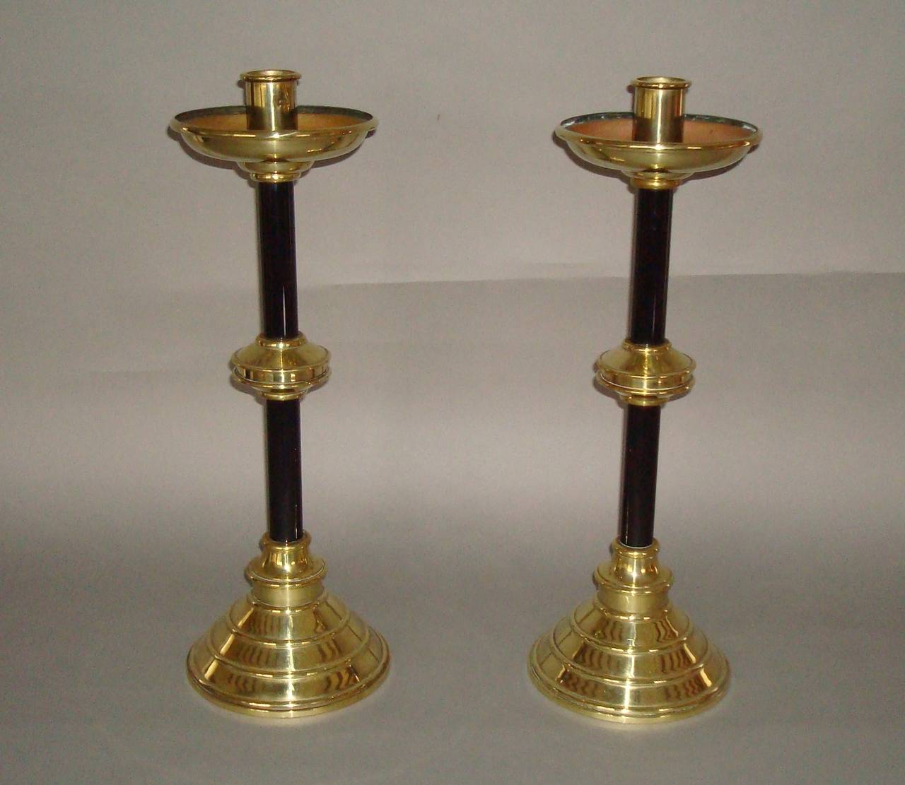 A C19th pair of candlesticks of ecclesiastical design, stamped 