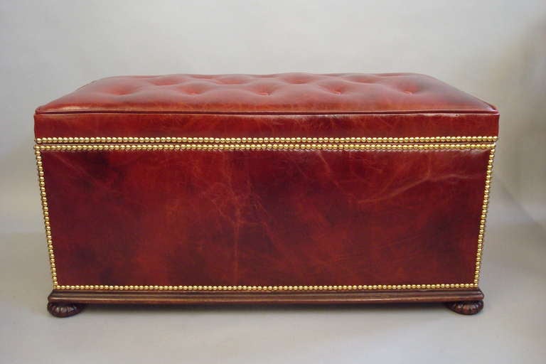 A good 19th century Gillows leather box ottoman, newly upholstered in burgundy leather with brass studs, the lift up lid buttoned and with a piped edge, revealing a large lined storage compartment; the ingeniously engineered stop hinges, prevent the