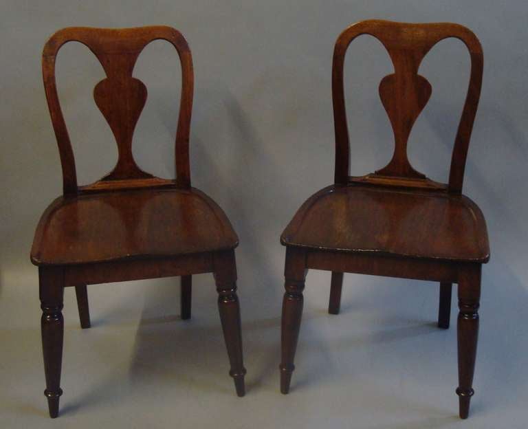 Rare pair of George III mahogany child's chairs, the shaped back incorporating a solid vase splat leading to a dished shaped solid seat raised on turned forelegs, (unusually splayed at an angle to provide more stability).  Retaining a lovely colour