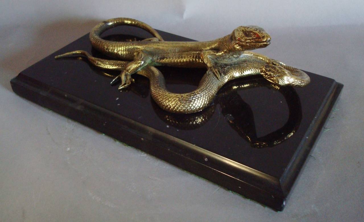 C19th gilt bronze of snake and lizard, this finely cast subject depicting a lizard grappling with a cobra, mounted on a black marble plinth base with a moulded edge and green baize to the underside.   This unusual bronze, would look great on a desk