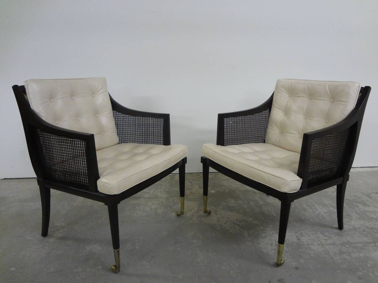 Pair of modern Probber style chairs with cane sides and leather, tufted seats. Brass trim to rear leather panel and front feet as shown.