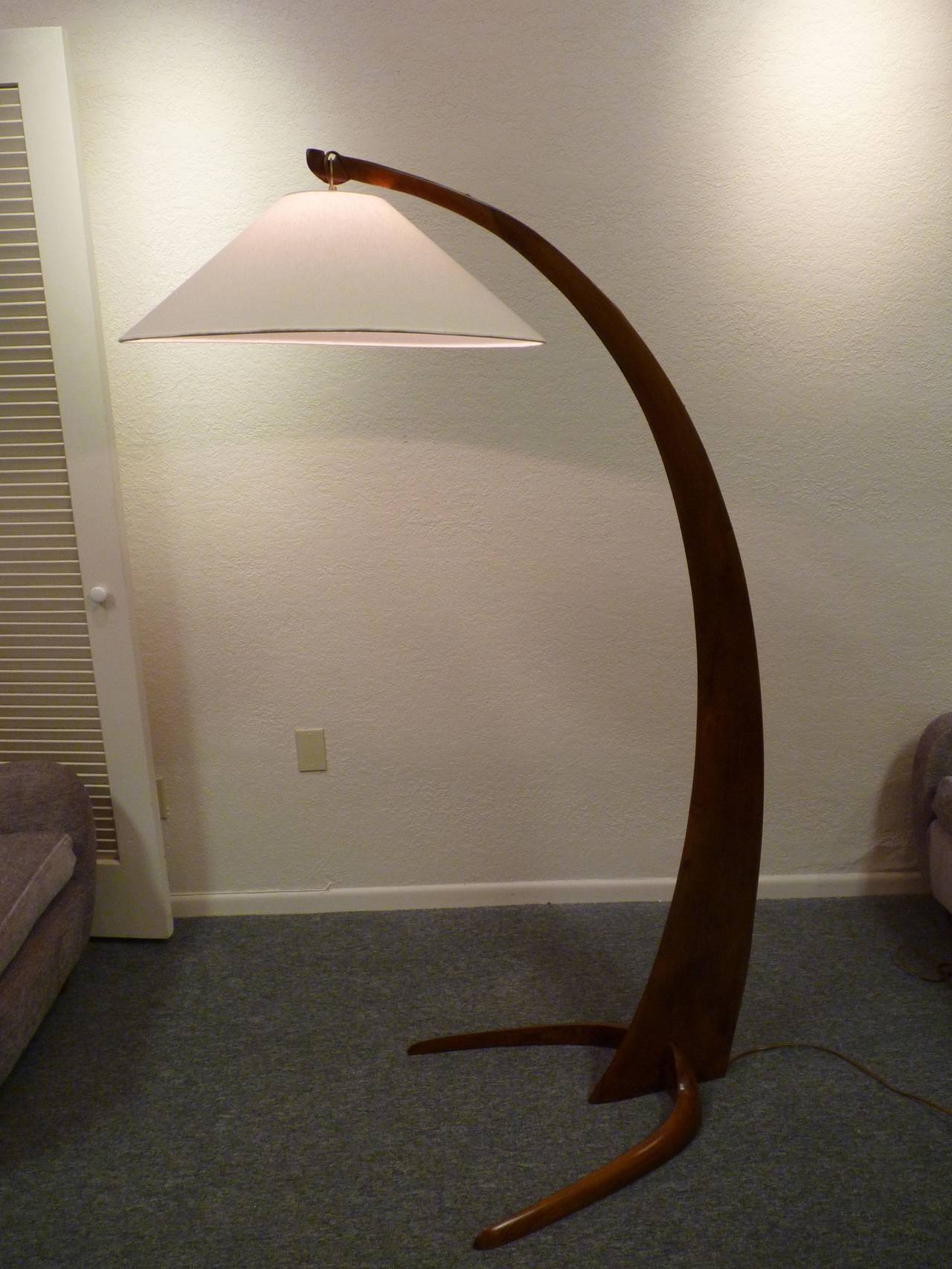 Italian arc floor lamp in walnut, circa 1950s.