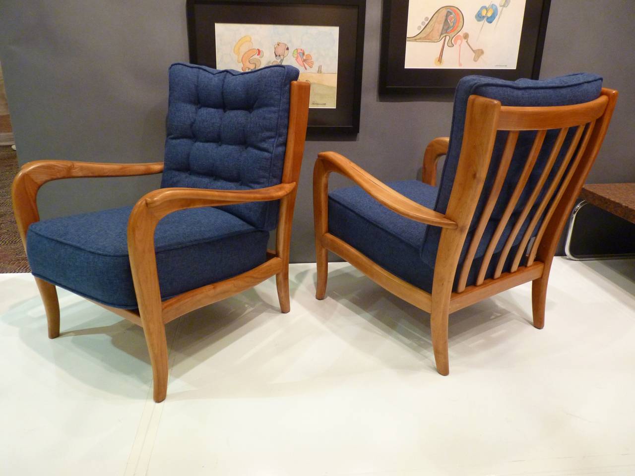 Pair of chairs attributed to Paolo Buffa made of solid Italian walnut, circa 1950s. Original spring cushions have been preserved and upholstery is redone in a blue fabric similar to original as shown.