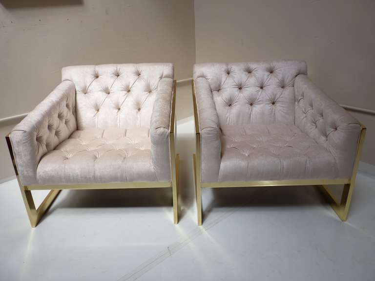 Pair of brass framed and tufted cantilevered lounge chairs in the manner of Milo Baughman for Thayer Coggin. New high polished brass to the frames with new upholstery.