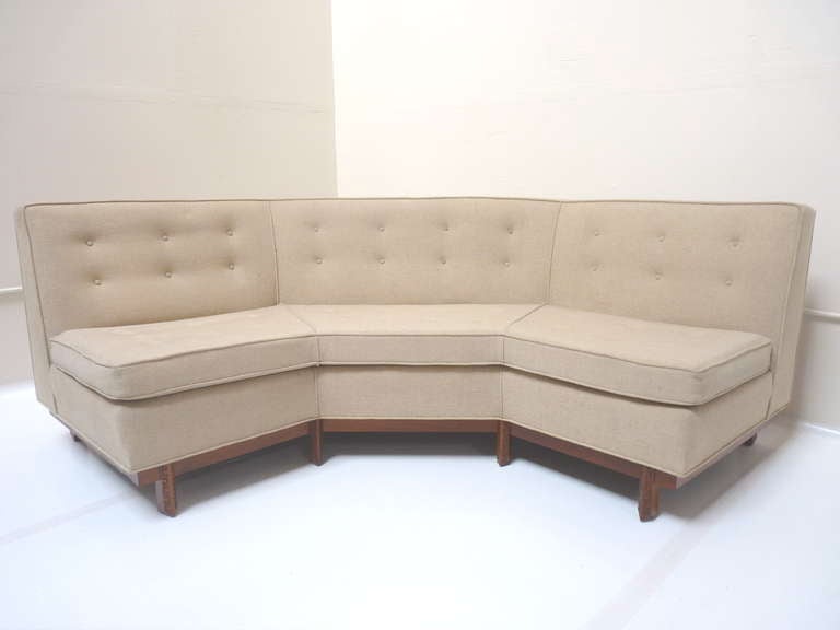 Angular tufted sofa with carved mahogany Taliesin frame base by Frank Lloyd Wright for Heritage Henredon c.1950s. This piece is offered in original condition,as pictured, or can be reupholstered in your choice of fabric for additional fee.