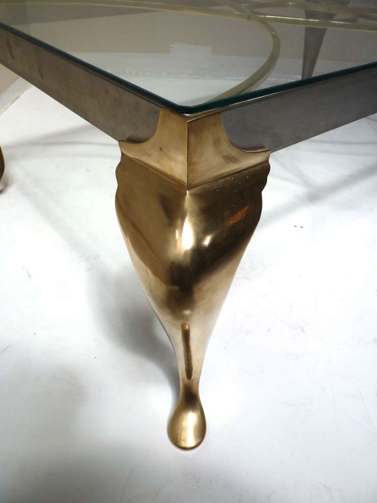 Brass & Stainless Cabriolet Leg Cocktail Table by Chapman. This piece, made in 1972, still sports its original tag to the underside of one leg as shown. Made of solid brass legs and detailing within the table frame, this piece looks great polished