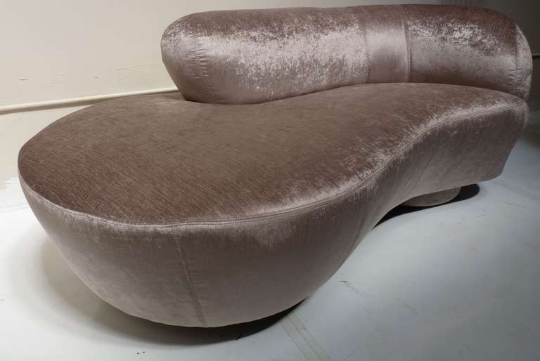 Petite Serpentine Sofa or Chaise by Vladimir Kagan for Directional on pedestal bases with center lucite support. This piece has been newly upholstered in a textured, taupe chenille and is a perfect scale for use as a chaise or bedroom seating.