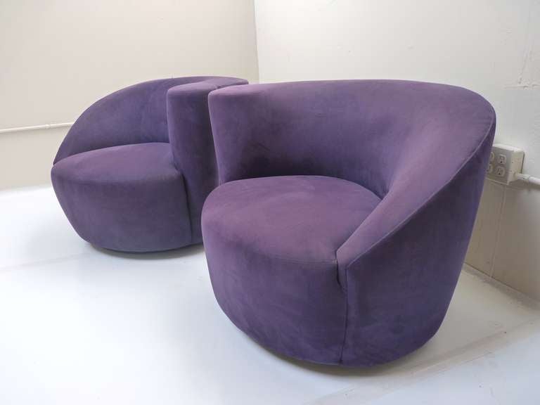 Pair of purple ultra-suede Nautilus chairs by Vladimir Kagan. Both chairs have smooth range of motion, as they swivel and return to center position.