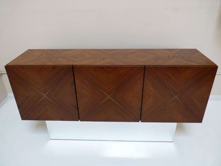 Rosewood Credenza by Milo Baughman for Thayer Coggin with restored base in a polished aluminum to a mirror shine. Outstanding grain and contrast in colors with a variety of sap that creates an exquisite pattern on doors. Entire interior is finished