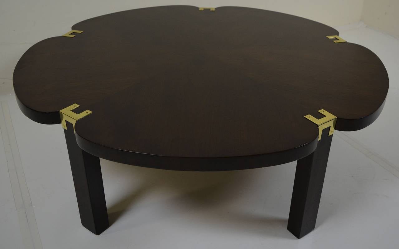 Classic, sophisticated cocktail table in walnut with brass accents manufactured by Heritage in November of 1958. In excellent condition with newly polished brass.