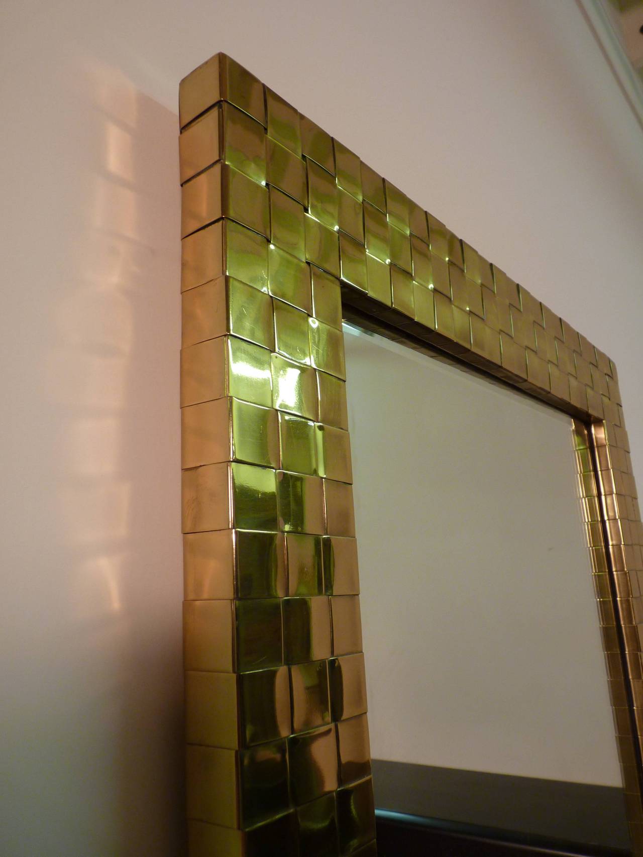 Woven brass mirror by Chapman, circa 1978. Mirrors look great vertically as shown or horizontally over a console or sofa. Original polished brass with clear coat in excellent condition. Signed and dated to rear.