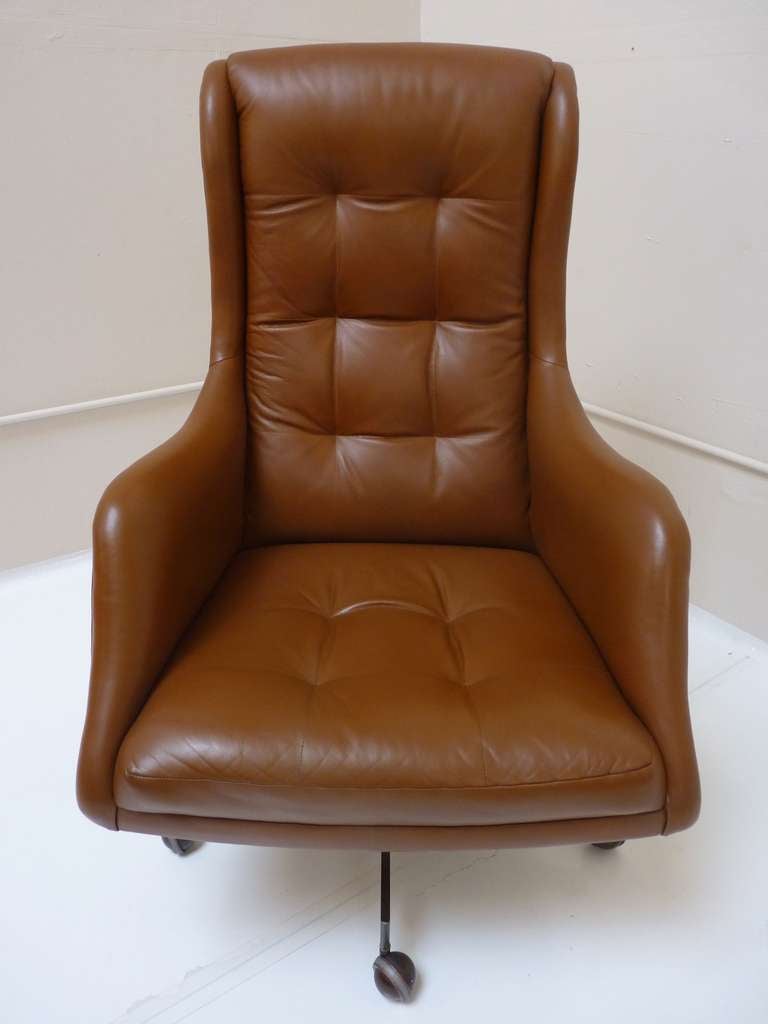 This executive desk chair by Vladimir Kagan is fitted in the finest leather and is made with top quality craftsmanship. The original leather is restored and the solid bronze base has a patina expected with age. Original Vladimir Kagan Studios Tag is