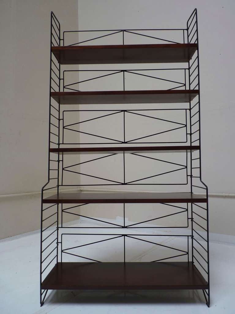 Adjustable shelves on Iron frame that folds flat for easy moving. Designed by Nisse Strinning in Sweden c.1950's