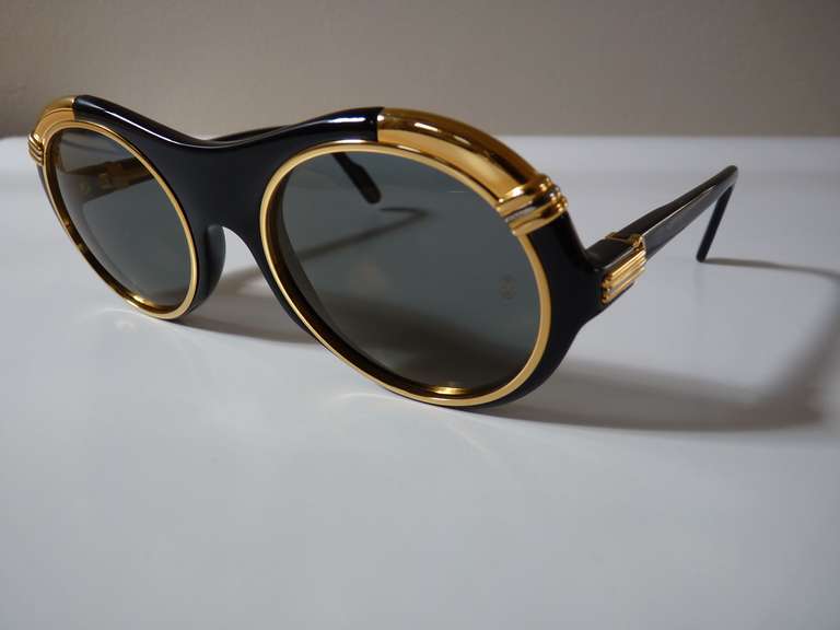 Out of the 1991 Cartier collection come these fantastic, rare, and most sought after Cartier sunglasses. They sport a 18k gold plated frame with photochromic lenses. Great for day or night use!