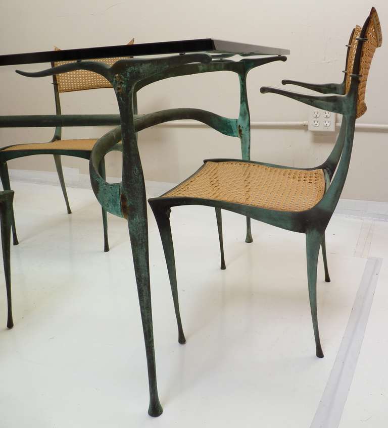 Gazelle Dining Set in Bronze by Dan Johnson. Cast bronze gazelle table, model 33B with original glass in good condition. Three model, 20B armchairs, and one model 10B side chair. Entire set is in very nice original condition. Chairs were re-strapped