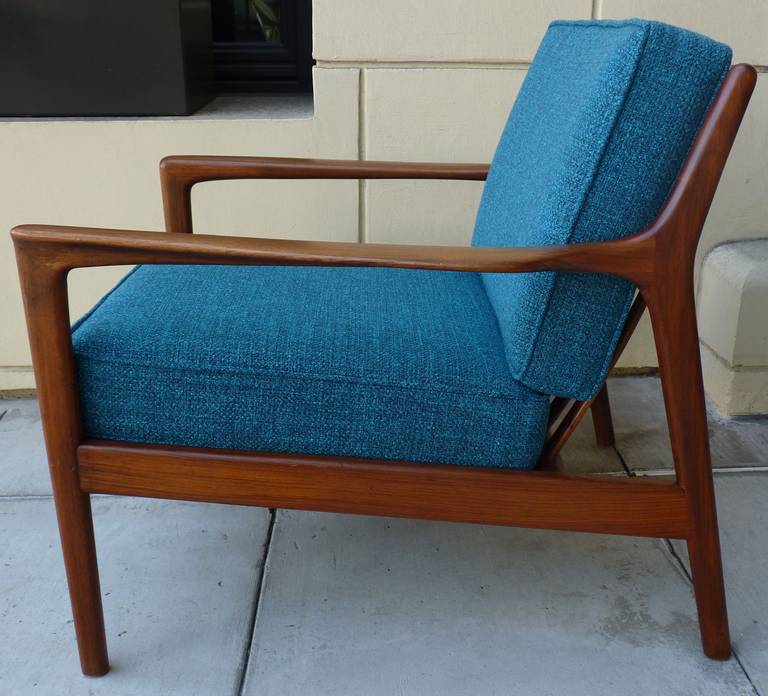 Lounge Chair by Folke Ohlsson for DUX. Made of Solid Walnut. Sculpted back has a slight curve adding great comfort and design appeal. Chair is in excellent original condition with new strapping and upholstery.