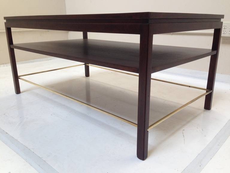 Tall Cocktail in Walnut by Edward Wormley for Dunbar circa 1950s. Table features a lower shelf as well as solid brass detail around perimeter. 22