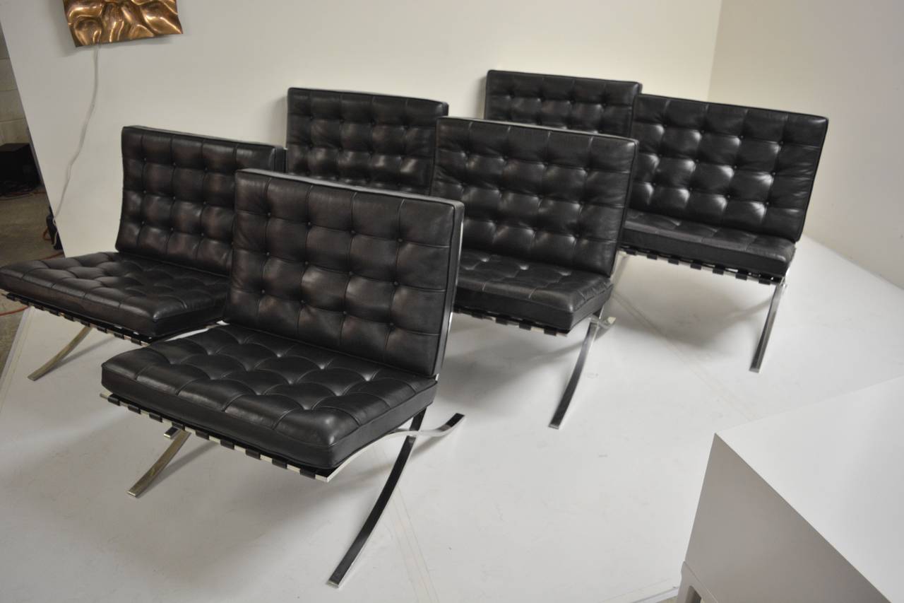 Designed in 1930 by Ludwig Mies van der Rohe, the Barcelona chair remains an icon of modern design. This grouping is made up of fourteen black leather Barcelona chairs manufactured in 1985, which have seen very limited use and are in exquisite