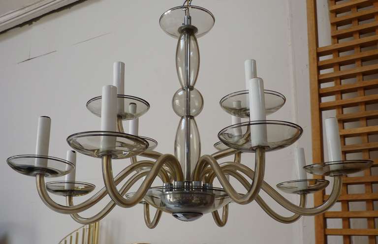 Glass 12 arm Murano Chandelier c.1960's in grey. Overall in very nice original condition. Wiring is in excellent working order and this piece has no flaws to speak of- only wear expected with age. Chandelier sold with chrome chain and canopy.