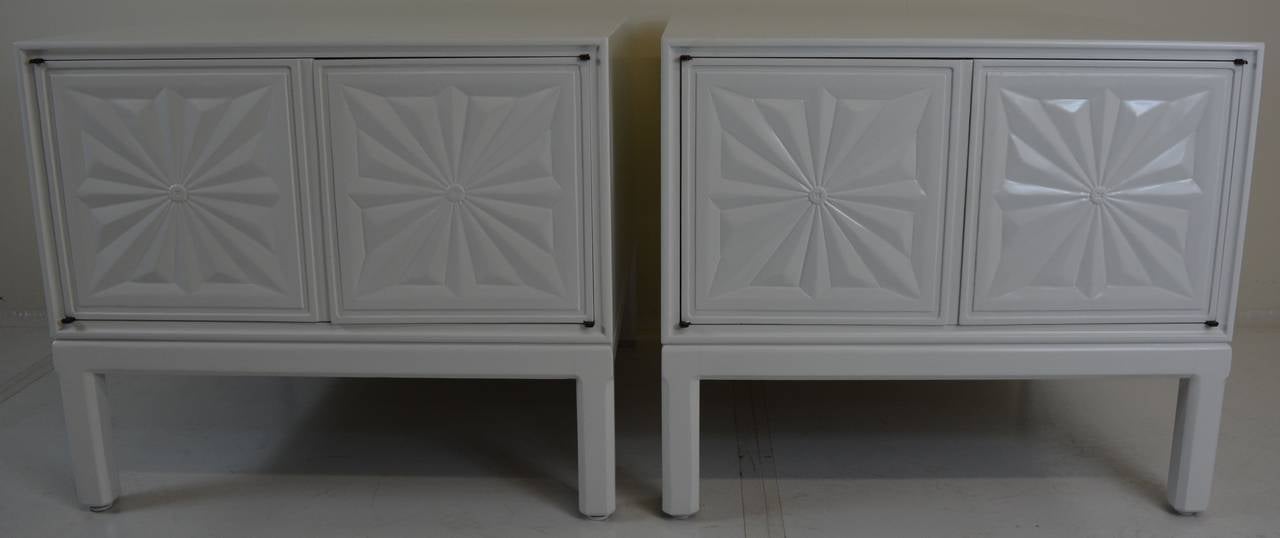 Pair of oak tables featuring carved starburst door panels. White lacquered finish provides a polished chic look that could place these as nightstands or side tables. Original brass hinges, Solid construction.